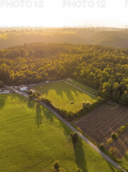 Light and shadow over green meadows and forest at sunset, VFL Stammheim, Calw, Black Forest,