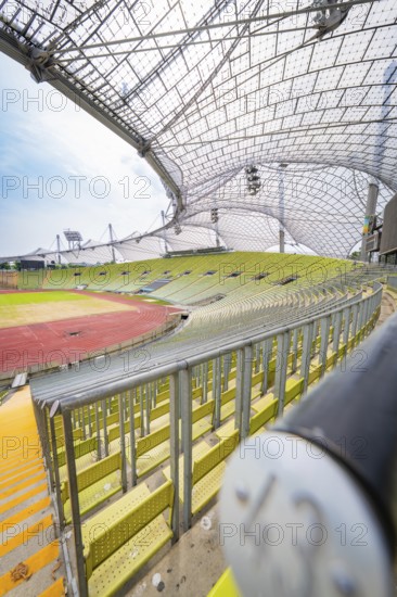 Close-up in the stadium with empty seats and striking roof construction, Olympiapark, Munich,
