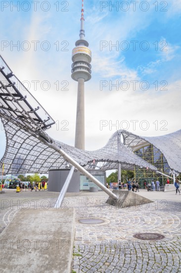 Impressive architecture below a television tower with modern design under a blue sky, Olympic Park,