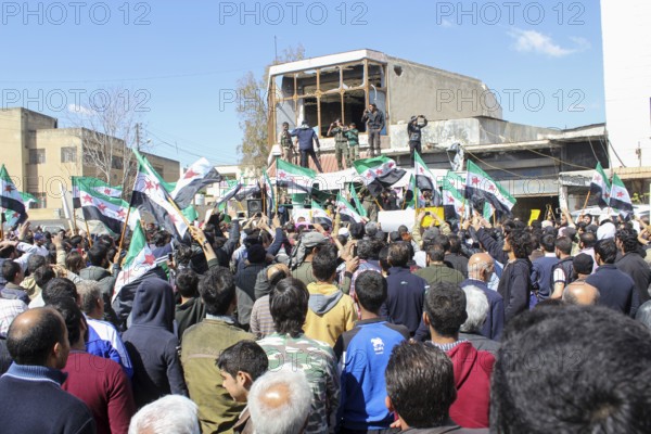 Civilians demonstrating in support of the Syrian revolution against the Bashar al-Assad regime.