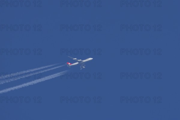 Boeing 747 jumbo jet cargo aircraft of Cargolux airlines with a vapour trail or contrail flying in