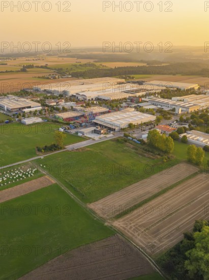 Industrial area with surrounding fields at sunset, industrial area Wolfsberg Nagold, district Calw,