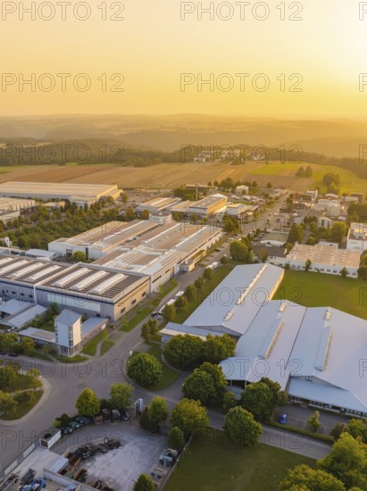 Industrial area at sunset with fields and green areas in the background, industrial area Wolfsberg