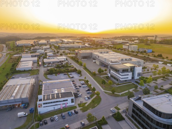 Spacious industrial estate at sunset with organised streets and modern buildings, Wolfsberg Nagold