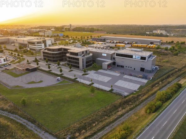 Commercial area with modern buildings and streets in a rural setting in the evening, industrial