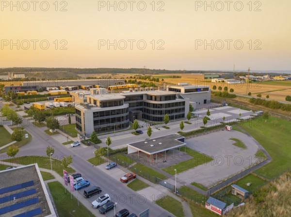 Modern office buildings and car parks in an urban setting at sunset, Wolfsberg Nagold industrial