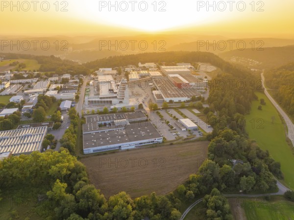 Industrial area with neighbouring forest and country road at sunset, industrial area Wolfsberg