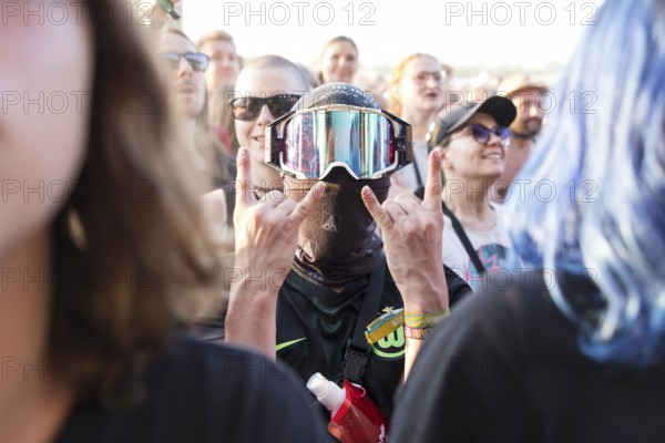 A festival visitor with a ski mask in the audience at the Highfield Festival on Saturday,