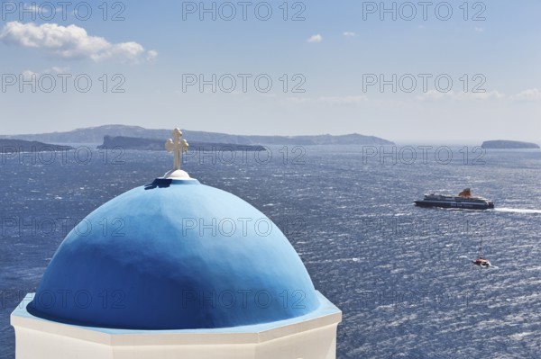Blue dome of an orthodox church, ferry crossing the sea, Caldera, Oia, Thira, Santorini, Cyclades,