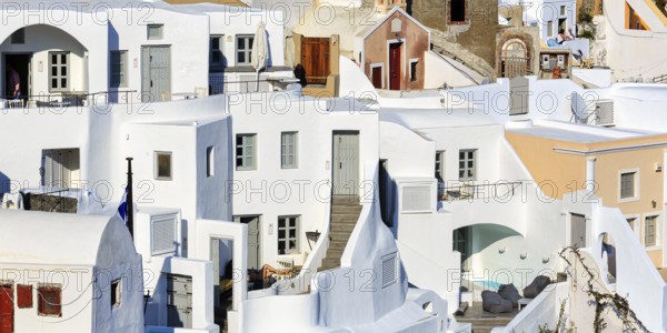 White and colourfully painted holiday homes on a steep slope, stairs, narrow alleys, Oia, Thira,