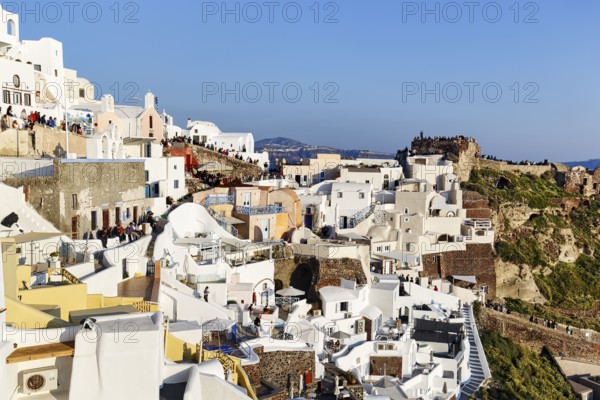 Tourists, crowd waiting for sunset in narrow alleys, Agios Nikolaos Castle, Oia, Thira, Santorini,
