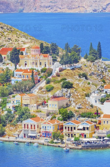 Colourful houses and Evangelismos church at the Harani Bay, Gialos, Symi Island, Dodecanese