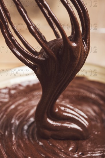 A bowl of chocolate dough, a whisk for whipping, baking, structure and consistency, homemade, top