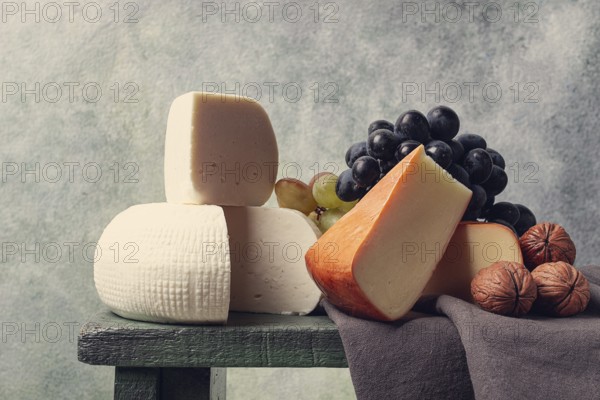 Georgian cheese, Imeretian and smoked suluguni, grapes, nuts, on a cutting board, Georgian cuisine,