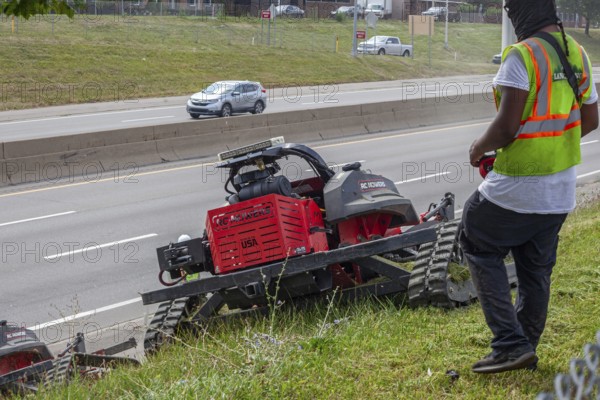 Harper Woods, Michigan, Remote-control mowers are cutting the grass and weeds along Interstate 94