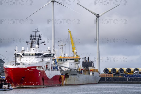 Working vessels in the seaport of Eemshaven, dredger Vitus Bering, aft, cable layer and offshore