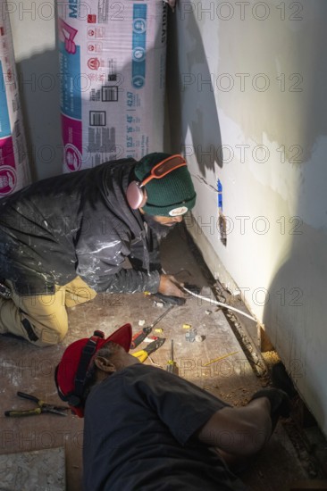 Detroit, Michigan - Workers remodel a house in the Morningside neighborhood that had been vacant