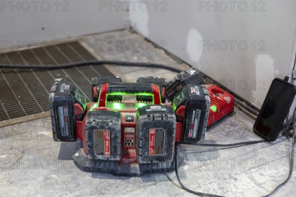 Detroit, Michigan - Batteries for power tools recharge as workers remodel a house in the