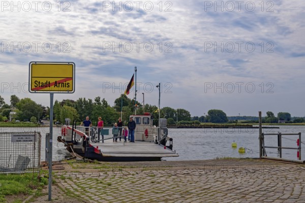 Ferry across the Schlei and town sign at the pier of Arnis, the smallest town in Germany. Arnis,