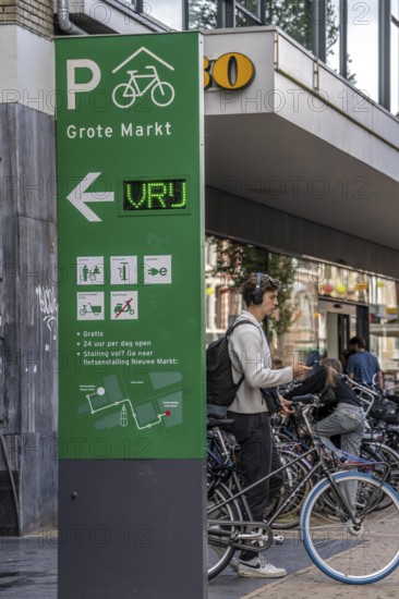 Cycling in the city centre of Groningen, old town, entrance to the bicycle parking garage at the