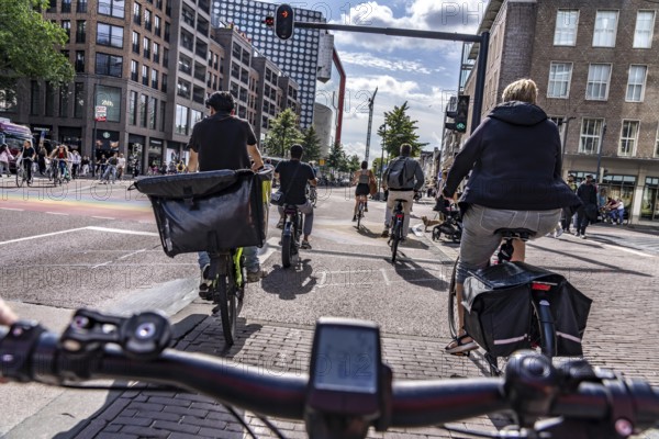 Ride your bike on the central cycle path on Lange Viestraat, Vredenburg, in the city centre of