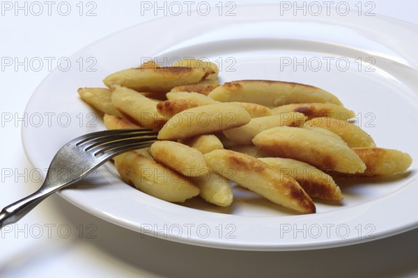 Fried puff noodles with fork on plate