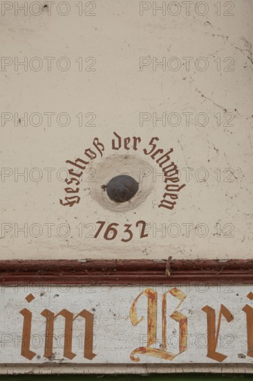 Old cannonball from 1632 in the wall of the bridge house on the Nahe bridge in Bad Kreuznach,