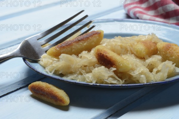Fried puff noodles with sauerkraut on plate
