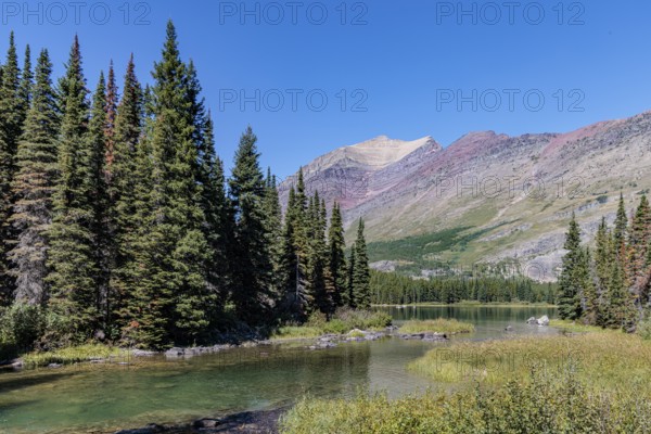 240831_301 Rugged Mountains rise up behind the south end of Swiftcurrent lake in Glacier National