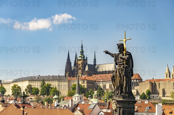 Statue of Saint John the Baptist on Charles Bridge in front of Prague Castle, Prague, Czech