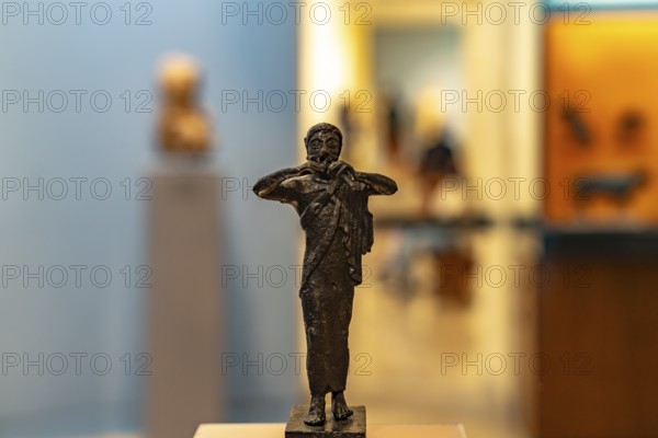 Bronze miniature of a flute player in the Archaeological Museum of Delphi, UNESCO World Heritage