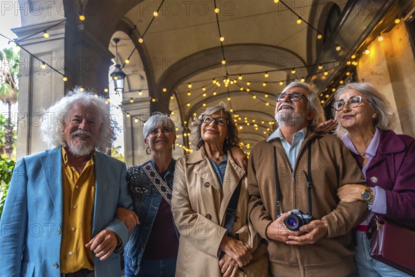 Senior friends strolling beneath a decorated arcade, smiling and looking up as they enjoy a sunny
