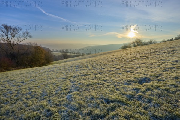 Soft sunlight and frost over a range of hills on a clear morning, Seckmauern, Lützelbach, Maintal,