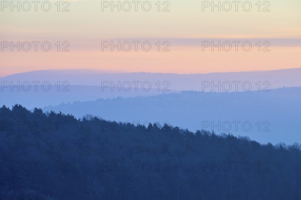 Shady hills and a calm pastel sky at sunset create a quiet atmosphere, Seckmauern, Lützelbach,