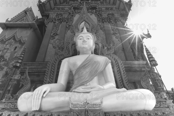 Buddha statue with tunic, Bhumispara mudra, Buddha Gautama at the moment of enlightenment, at the
