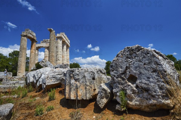 Large stones and ancient pillar remains under bright blue sky, Nemea, Ancient Zeus Heightum,