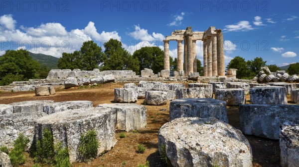Stone ruins with ancient columns against a blue sky and clouds, Nemea, Ancient Zeus Heightum,