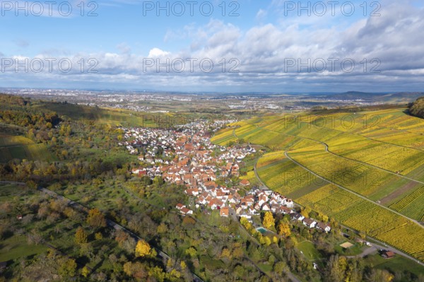 Wine village in colorful vineyards under a cloudy but clear autumn sky, Strümpfelbach im Remstal,