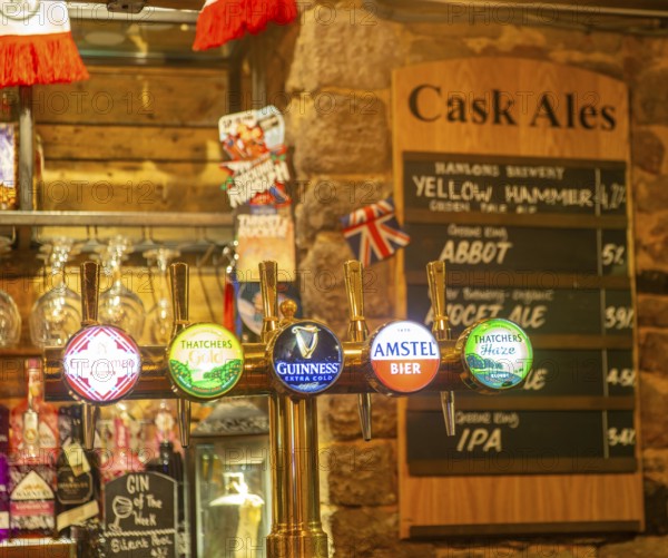 Keg beer taps and labels of different brands inside The Ship pub, Exeter, Devon, England, UK - cask