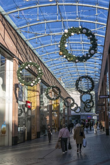 Christmas shoppers inside covered shopping street, Princesshay shopping centre, Exeter, Devon,