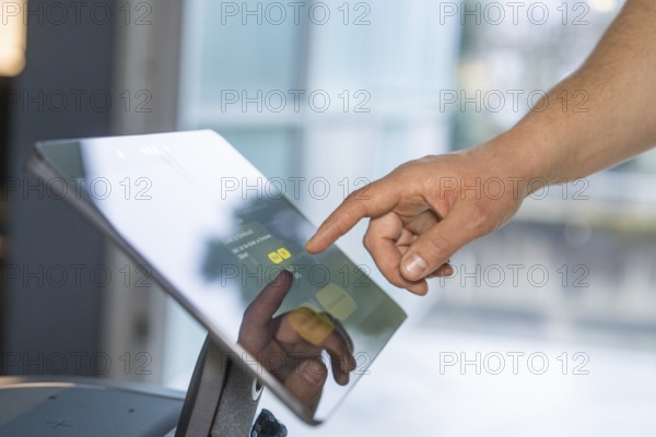 Close-up of a hand interacting with a touchscreen in a modern setting, robotic personality