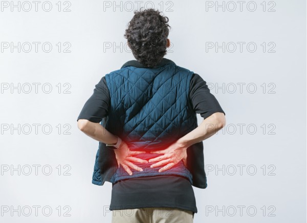 Person with spine problems. Man with pain holding his back. Lumbar problems. Suffering male with