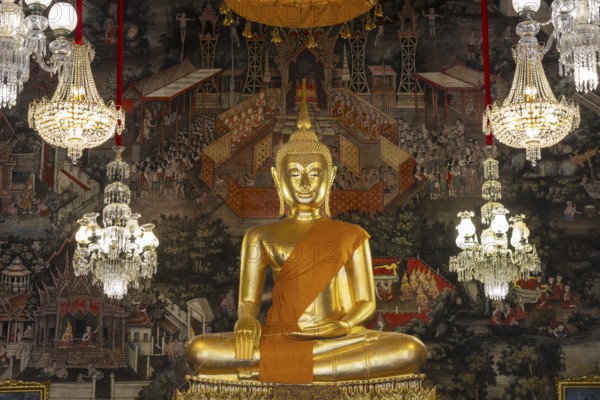 Golden Buddha statue, Phra Buddha Trilokachet surrounded by crystal chandeliers and exquisite wall