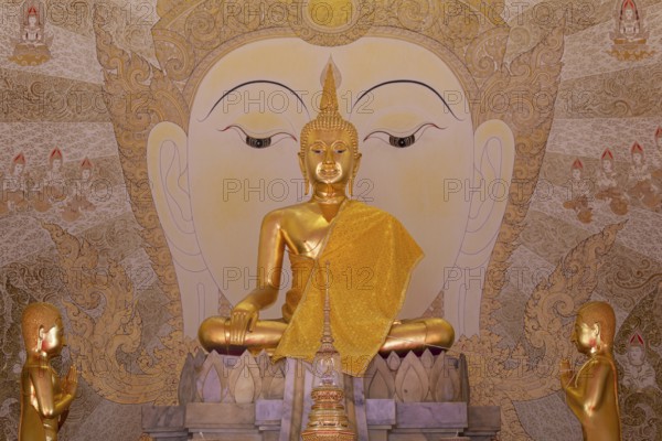Golden Buddha statue with tunic, Bhumispara mudra, Buddha Gautama at the moment of enlightenment,