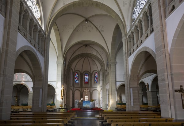 Large church interior view with arches, glass windows and altar in a quiet atmosphere, Boniface