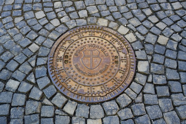 Round metal manhole cover on paved ground with interesting structure, manhole cover, Hünfeld,