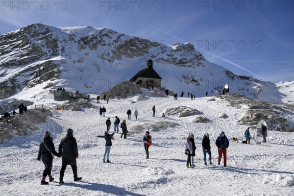 Tourists at the Heimsuchung chapel on Zugspitzplatt, Grainau municipality, Garmisch-Partenkirchen