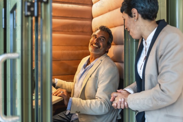 Business professionals having an engaging conversation, discussing work in a contemporary private