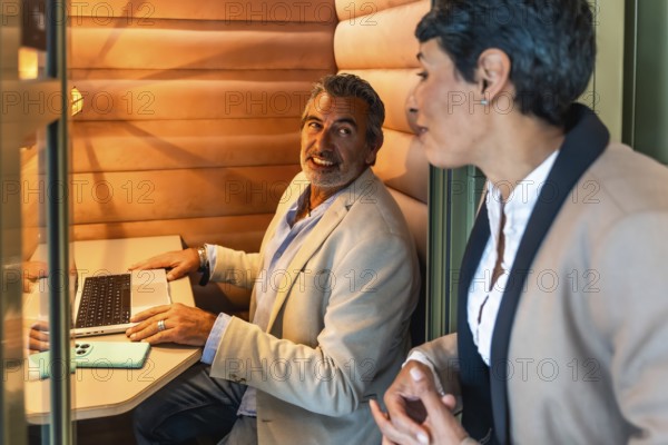 Business colleagues having a relaxed discussion and working together in a cozy, soundproofed