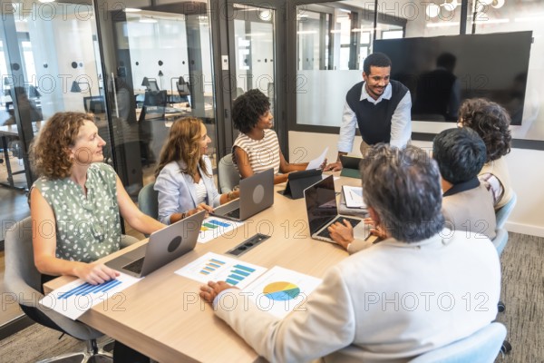 Diverse business professionals conducting a collaborative meeting in a modern office, analyzing